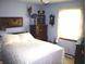 A cozy bedroom with wood furniture and a bright window at 14544 Lynn Ave, Fishers, IN 46038