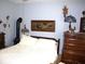 Cozy bedroom with a decorative lamp and wood furniture at 14544 Lynn Ave, Fishers, IN 46038