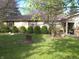 Charming single-story home featuring mature trees, manicured shrubs, and classic shutters at 14544 Lynn Ave, Fishers, IN 46038