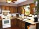 Traditional kitchen with wooden cabinetry, laminate countertops, and appliances at 14544 Lynn Ave, Fishers, IN 46038