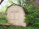 Back of storage shed in wooded backyard features colorful vegetation at 14544 Lynn Ave, Fishers, IN 46038