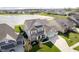 Aerial view of a meticulously landscaped property, featuring a pond and neighborhood setting at 15986 Bugle Ridge Dr, Noblesville, IN 46060