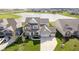 Aerial view showcases a well-maintained home with a spacious lot and scenic pond views at 15986 Bugle Ridge Dr, Noblesville, IN 46060