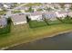 Aerial view of well-kept neighborhood homes, showing backyard with lawn and community pond at 15986 Bugle Ridge Dr, Noblesville, IN 46060