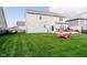 Spacious backyard with well-manicured lawn, deck, and patio furniture for relaxation and entertainment at 15986 Bugle Ridge Dr, Noblesville, IN 46060
