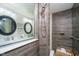 Modern bathroom with stylish wood-look tile, frameless glass shower, and double vanity sinks at 15986 Bugle Ridge Dr, Noblesville, IN 46060