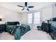 Spacious bedroom with ample natural light, ceiling fan, and plush carpet at 15986 Bugle Ridge Dr, Noblesville, IN 46060