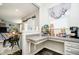 Convenient coffee station with granite countertops and storage cabinets sits adjacent to open-concept dining and living area at 15986 Bugle Ridge Dr, Noblesville, IN 46060