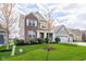 Beautiful two-story home with a brick and siding exterior, manicured lawn, and a charming front porch at 15986 Bugle Ridge Dr, Noblesville, IN 46060