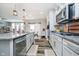 Well-lit kitchen with granite countertops, stainless steel appliances, and wood-look flooring at 15986 Bugle Ridge Dr, Noblesville, IN 46060