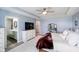 Spacious main bedroom with light blue walls, neutral carpet, ceiling fan, and ensuite bathroom at 15986 Bugle Ridge Dr, Noblesville, IN 46060