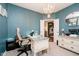Office with blue walls, plush carpet, chandelier, and decorative white vintage desk and cabinet at 15986 Bugle Ridge Dr, Noblesville, IN 46060