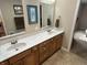 Well-lit bathroom featuring a double vanity with a pristine white countertop and wood-finished cabinetry at 160 Bay Ridge Dr, Pendleton, IN 46064
