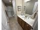 Well-lit bathroom featuring a single sink, wood cabinets, and a large mirror at 160 Bay Ridge Dr, Pendleton, IN 46064