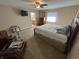 Cozy bedroom with a ceiling fan, TV, and view into the bathroom at 160 Bay Ridge Dr, Pendleton, IN 46064