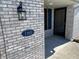 Close-up of the front door and brick facade featuring house number and covered entryway at 160 Bay Ridge Dr, Pendleton, IN 46064