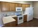 Bright kitchen with white appliances, laminate countertops, and wood cabinetry at 160 Bay Ridge Dr, Pendleton, IN 46064