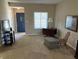 Cozy living room with neutral carpet, blue front door, and ample natural light at 160 Bay Ridge Dr, Pendleton, IN 46064