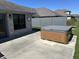 Back patio view, showcasing the private hot tub for relaxation and leisure and the fenced backyard at 160 Bay Ridge Dr, Pendleton, IN 46064