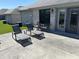 Relaxing patio area featuring lounge chairs, table and chairs set, and easy access to the house through a glass door at 160 Bay Ridge Dr, Pendleton, IN 46064