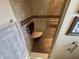 Tiled shower area with a built-in seat and grab bar for safety and convenience at 160 Bay Ridge Dr, Pendleton, IN 46064