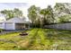 Spacious backyard with a fire pit and mature trees at 1733 N Spencer Ave, Indianapolis, IN 46218