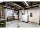 Unfinished basement with washer, dryer, and concrete floor at 1733 N Spencer Ave, Indianapolis, IN 46218