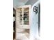 Classic white china cabinet with glass doors, shelves, and drawer providing ample storage in the kitchen at 1733 N Spencer Ave, Indianapolis, IN 46218
