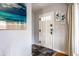 Welcoming entryway with slate tile flooring, white door, and calming wall decor at 1733 N Spencer Ave, Indianapolis, IN 46218