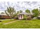 Charming brick home with a well-maintained lawn and a welcoming red front door at 1733 N Spencer Ave, Indianapolis, IN 46218