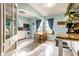 Charming kitchen with blue walls, tile floors, white cabinets, and a breakfast table at 1733 N Spencer Ave, Indianapolis, IN 46218