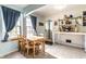 Bright kitchen with a wooden dining table, white walls and natural light from the large windows at 1733 N Spencer Ave, Indianapolis, IN 46218
