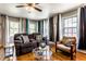Bright living room with hardwood floors, a comfortable sofa, and plenty of natural light at 1733 N Spencer Ave, Indianapolis, IN 46218