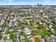 An aerial view showcases a neighborhood with mature trees, building details and downtown skyline at 1917 Fletcher Ave, Indianapolis, IN 46203