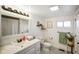 Well-lit bathroom featuring a modern sink, decorative mirror and black and white floor tiles at 1917 Fletcher Ave, Indianapolis, IN 46203