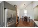 View of the kitchen and dining area with brick column and stainless steel refrigerator at 1917 Fletcher Ave, Indianapolis, IN 46203