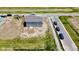 Aerial view of a new construction home with a spacious backyard and newly installed concrete patio at 196 Aster Way, Greenfield, IN 46140
