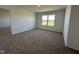 Bedroom featuring neutral carpeting, a window for natural light, and ample space at 196 Aster Way, Greenfield, IN 46140