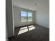 Bedroom with large window letting in bright sunlight and featuring neutral carpeting at 196 Aster Way, Greenfield, IN 46140