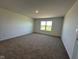 Bedroom featuring neutral carpeting, a window for natural light, and ample space at 196 Aster Way, Greenfield, IN 46140