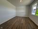 A bedroom with wood flooring, white walls, and a window allowing ample natural light at 196 Aster Way, Greenfield, IN 46140