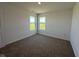 Bedroom featuring neutral carpeting, two windows for natural light, and ample space at 196 Aster Way, Greenfield, IN 46140