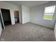A spacious bedroom with neutral carpet, bright natural light, and an ensuite bathroom at 196 Aster Way, Greenfield, IN 46140