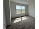 Sunlit bedroom featuring neutral carpet and a large window with neighborhood views at 196 Aster Way, Greenfield, IN 46140