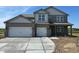 New construction two-story home with brick accents and a three car garage at 196 Aster Way, Greenfield, IN 46140