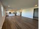 Bright and spacious living room featuring wood floors and an open layout to the modern kitchen at 196 Aster Way, Greenfield, IN 46140