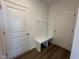 Mudroom with a bench and coat hooks, conveniently located near the entryway and interior doors at 196 Aster Way, Greenfield, IN 46140