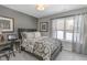 Cozy bedroom with a patterned bedspread, neutral walls, and a window overlooking a snowy landscape at 19600 Atwater Ave, Sheridan, IN 46069