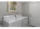 Laundry room with a washer and dryer, white door, and neutral wall paint at 19600 Atwater Ave, Sheridan, IN 46069