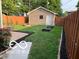 The backyard features green grass, raised garden beds and a patio area at 2001 Hoyt Ave, Indianapolis, IN 46203